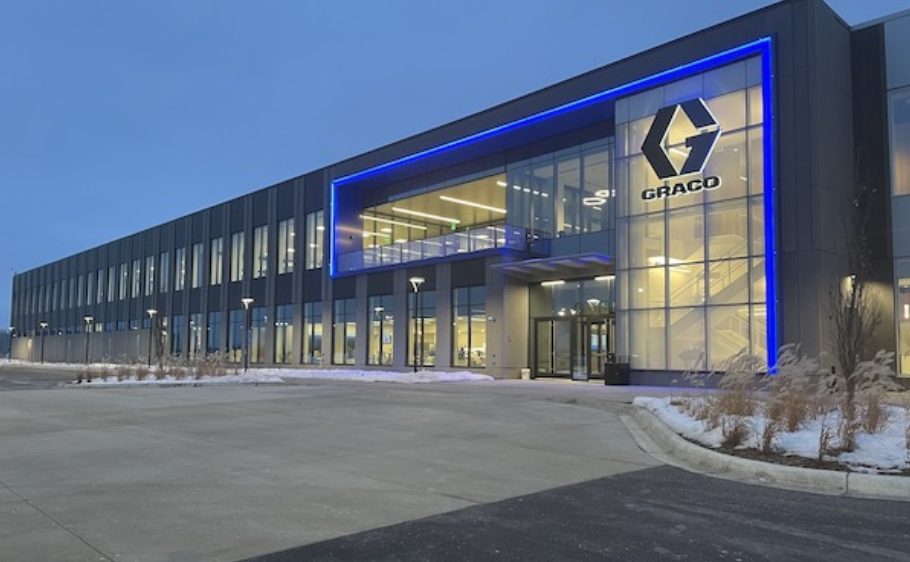 Graco diaphragm pump or automatic lubrication system installed on heavy equipment or industrial machinery.